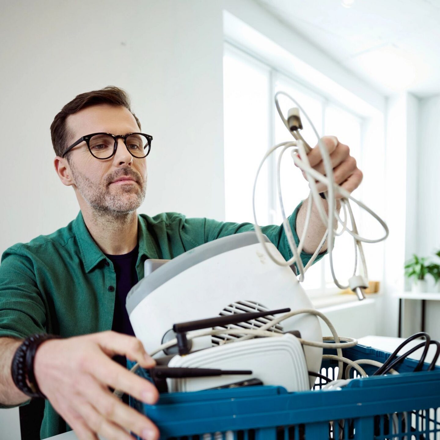 Man at standing desk in office collecting e waste - Replace this text with your SEO Title. NSF Landfill-Free Verification and Waste Diversion Leader Verification | NSF