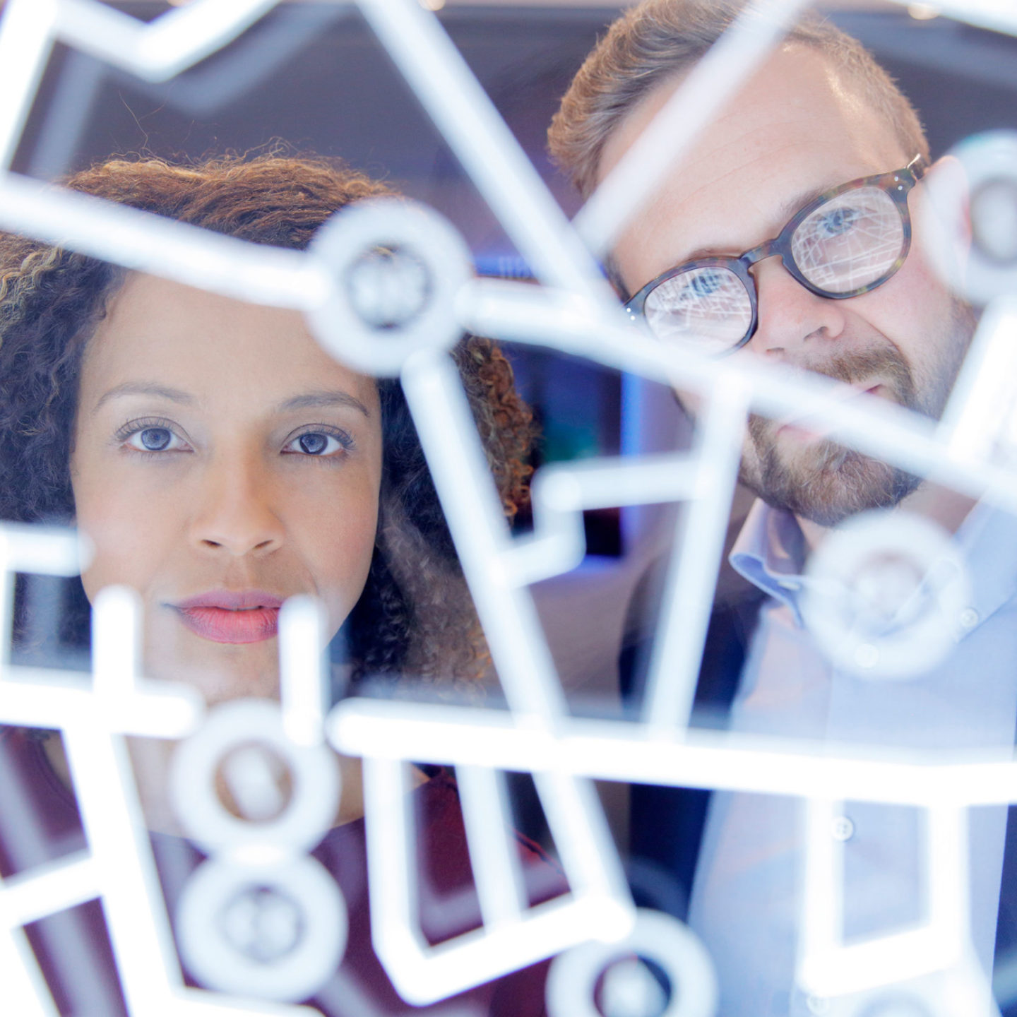 Business people looking through a futuristic digitally generated display