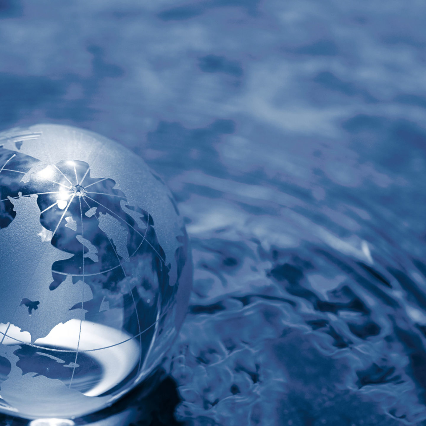 Glass globe sitting in a ripple of water