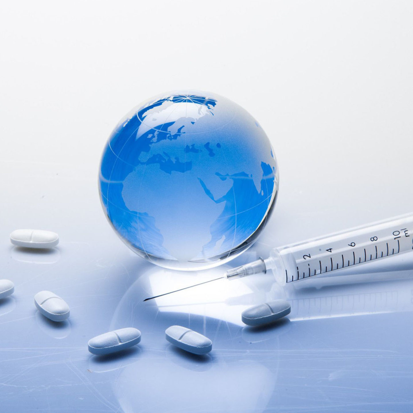 Blue globe with pills and syringe | NSF International