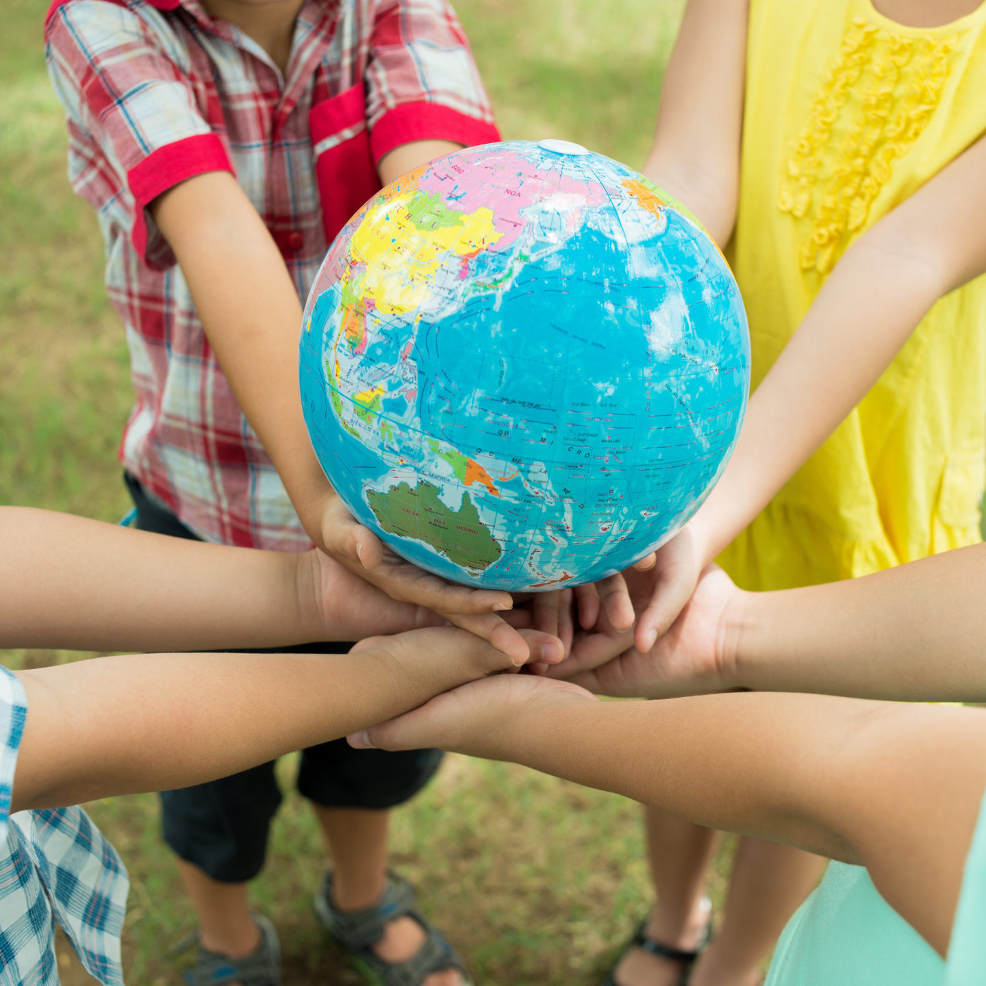 Kids hands holding globe