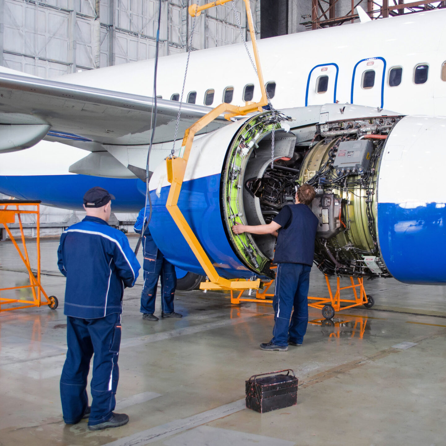 A man is repairing an Aeroplane engine - AS9100 Series Aerospace Certification | NSF