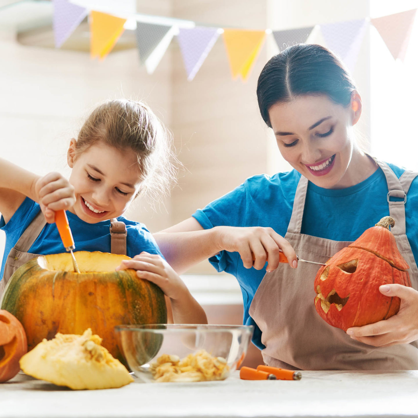 Mother and daughter carving pumpkins 108423489