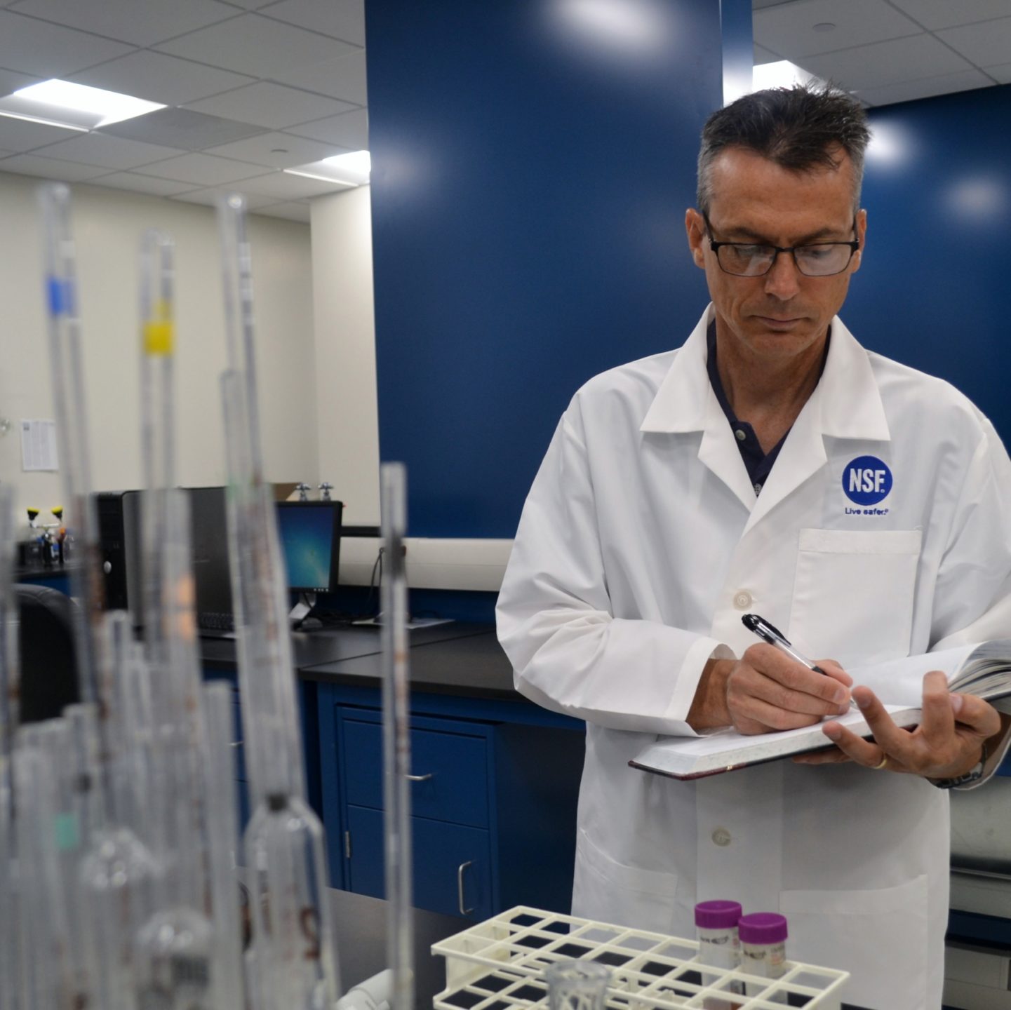 John Travis on notebook in lab