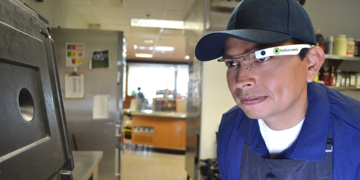 Retail food worker using EyeSucceed glasses to do an inspection