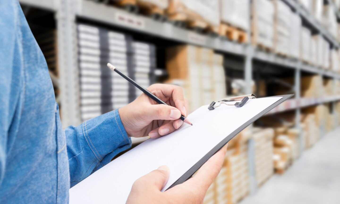 Person using clipboard in warehouse