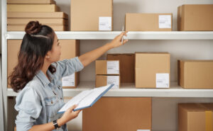 Women checking boxes on shelves Quality Management Systems (QMS) Certification