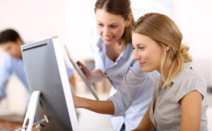 Women working together in front of computer - ISO/IEC 27001 Standard: Information Security Management | NSF