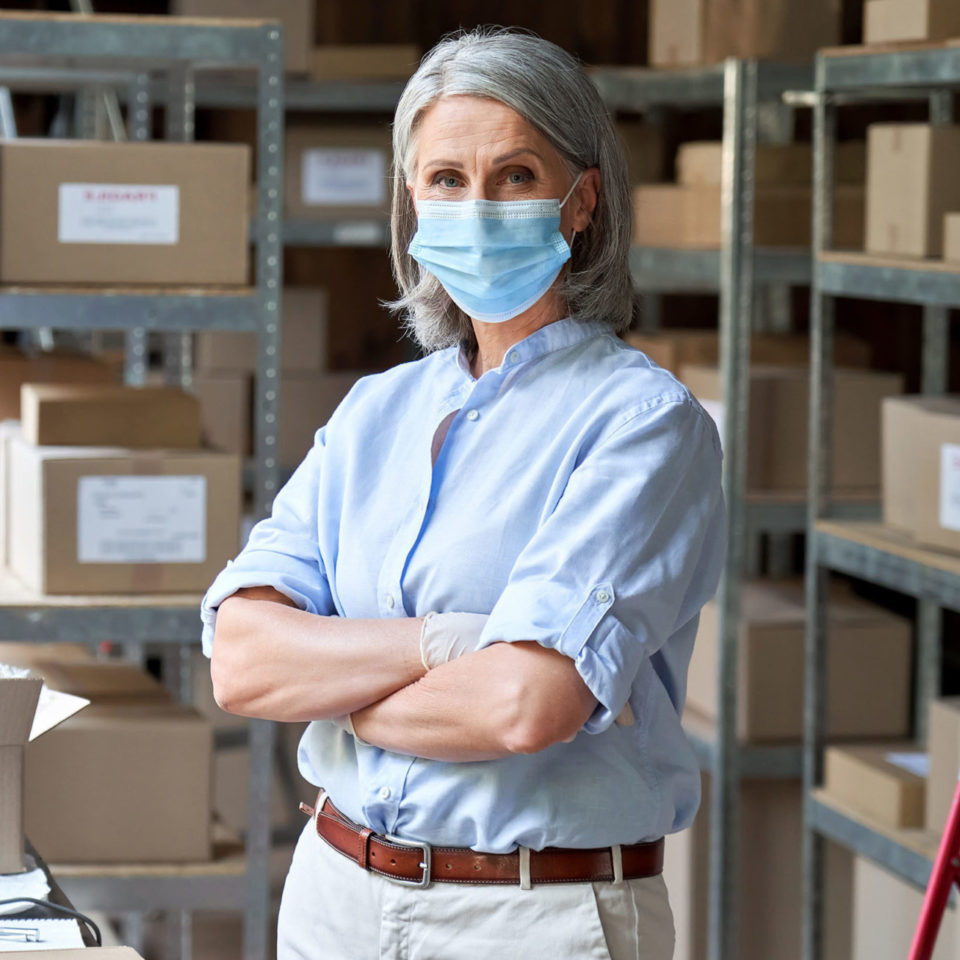 Woman wearing a mask in warehouse