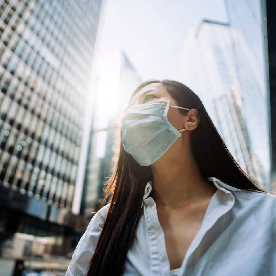 Woman wearing mask in city