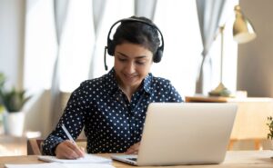 Woman writing headset laptop 136981192